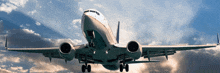 a large passenger jet is flying through a cloudy blue sky