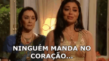 two women are standing next to each other and one of them is crying while the other is laughing .