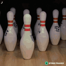 a bunch of bowling pins with one that says strike finance