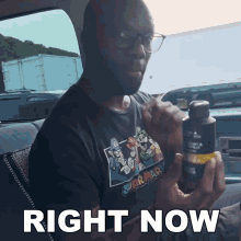 a man wearing a super mario shirt is holding a bottle and says right now in white letters