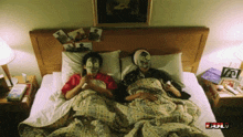 two people are laying in bed with their faces painted and the word bull is on the bottom