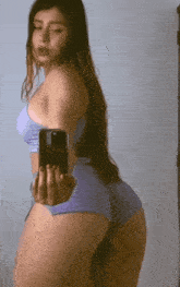 a woman is taking a picture of herself in a mirror