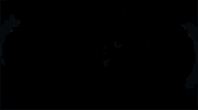 a man in a black suit is holding a shield in his hand .