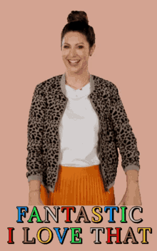 a woman wearing a leopard print jacket and an orange pleated skirt