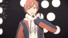a boy in a jacket that says rac on it is singing into a microphone