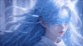 a girl with blue hair is wearing a blindfold