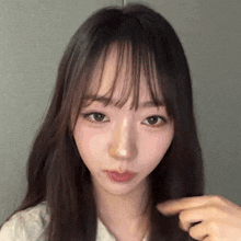a close up of a woman 's face with long hair .