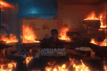 a man is standing in a kitchen with a bunch of fires
