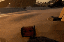 a treasure chest is sitting on a sandy beach in a video game
