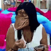 a woman with a strange face is sitting on a bed .