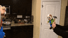 a person is holding a stuffed animal with a hammer in front of a door
