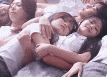 a group of girls are laying on top of each other