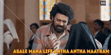 a man in a church with the words asale mana life antha antha maatram written above him