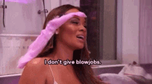 a woman is wearing a pink glove on her head and says `` i don 't give blowjob . ''
