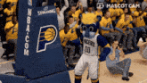 a mascot for the pacers stands in front of a crowd