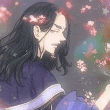 a man with long black hair is surrounded by pink flowers and stars