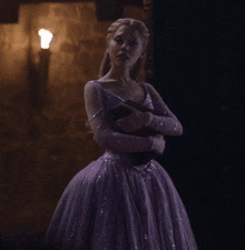 a woman in a purple dress with sequins on the sleeves