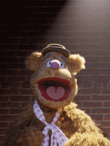 a stuffed animal wearing a hat and tie
