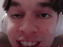 a close up of a person 's face with headphones