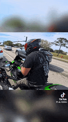 a man wearing a helmet is riding a motorcycle on the street