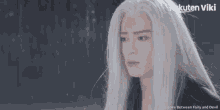 a woman with long white hair is crying with rakuten viki written on the bottom
