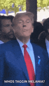 a man in a suit and tie is making a funny face and says whos taggin melania .