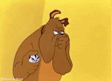 a cartoon dog is covering his nose while holding a kitten .