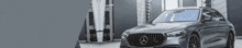 a mercedes benz is parked in front of a building