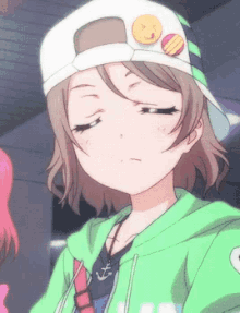 a girl wearing a green hoodie and a white hat with an emoji on it