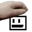a pixelated image of a hand holding a square with a smiley face on it .