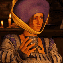 a woman wearing a purple hat is holding a silver goblet