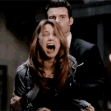 a man is tickling a woman with a knife while she screams .