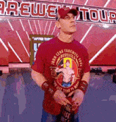 a man wearing a red shirt with a picture of john cena on it