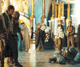 a group of people are standing around a man laying on the floor with the number 33 written on the floor
