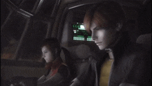 a man and a woman are sitting in front of a screen that says cc on it