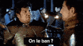 a man in armor is talking to another man with the words on le ban written below them