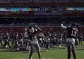 a football player with the number 13 on his jersey catches a pass