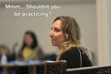a woman sitting in a chair with the words shouldnt you be practicing written above her