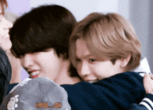 a group of young people hugging each other with one wearing a hat that says ms