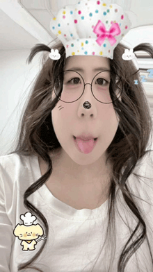 a woman wearing a chef 's hat and glasses sticking her tongue out
