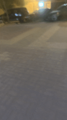 a blurry photo of a parking lot with cars parked