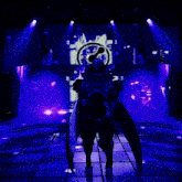 a person standing in front of a purple screen