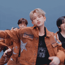 a group of people are dancing and one of them is wearing a jacket with a star on the pocket
