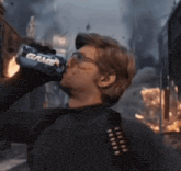 a man is drinking from a can that says game on it