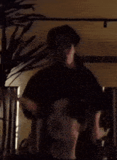 a blurred image of a man holding another man 's head