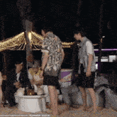 a group of people are gathered on a beach with a sign that says summer 2023 on the bottom