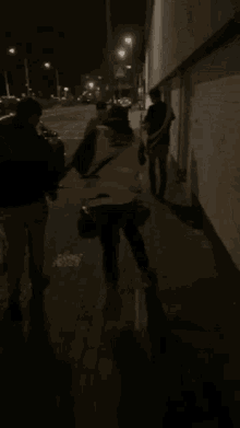 a group of people are walking down a street with a sign that says a on it