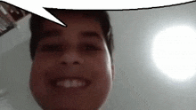 a man is smiling with a speech bubble above his head