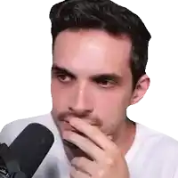 a man with a beard covering his mouth with his hand in front of a microphone