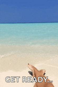 a person laying on a beach with the words get ready written below them